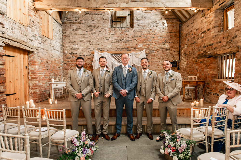 groom and groomsmen in beige suits at  milton end barn