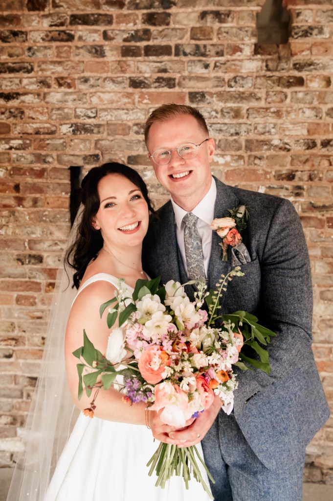 bride and groom smiling portrait at  milton end barn wedding