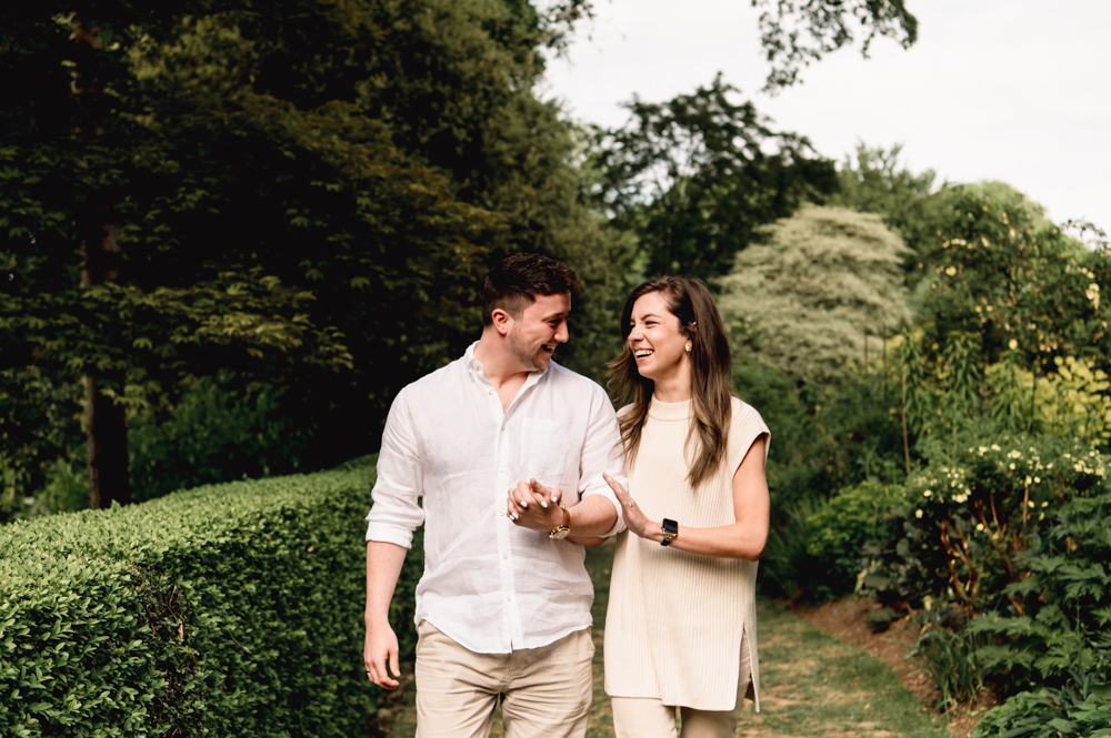 a couple walking in a garden cotswolds 