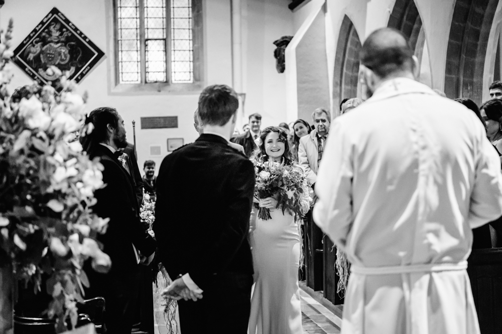 bride walking down the aisle church wedding cotswolds
