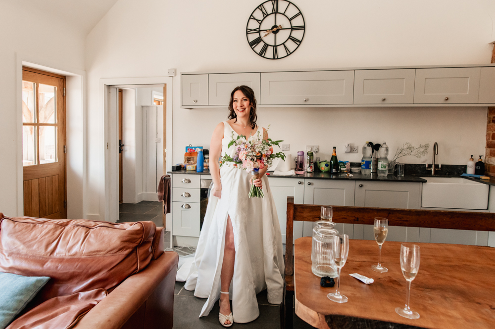 bride in a dress with a slit rustic wedding