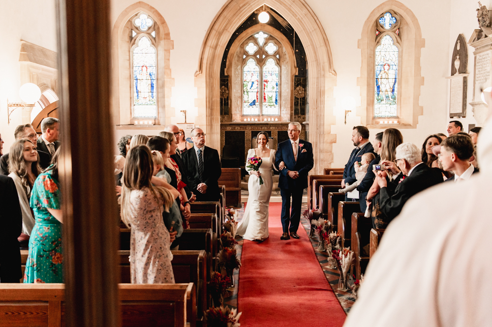 bride walking down the aisle owlpen manor cotswolds