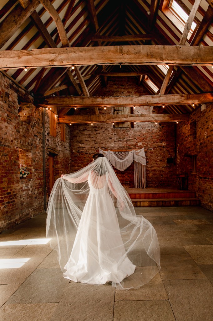 bride posing with veil vogue style wedding photography