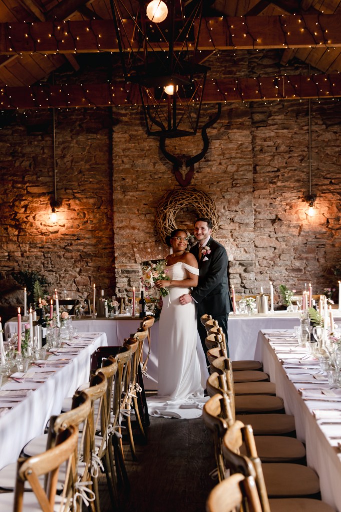 bride and groom in a warm cosy wedding barn 