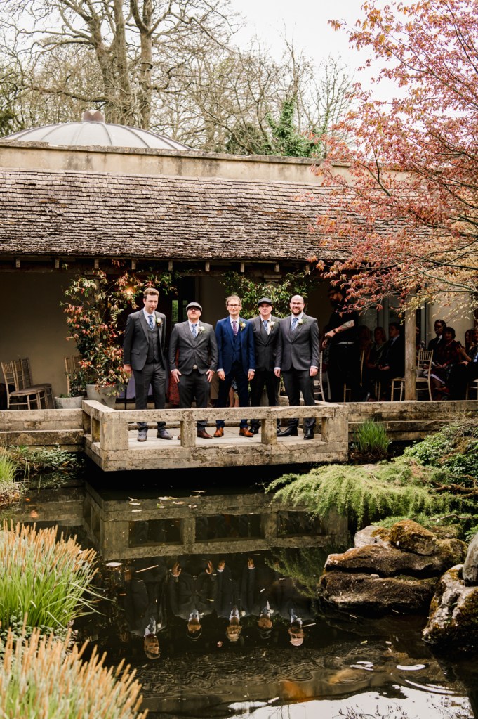 groom aand groomsmen by a pond  outdoor wedding at Matara centre cotswolds