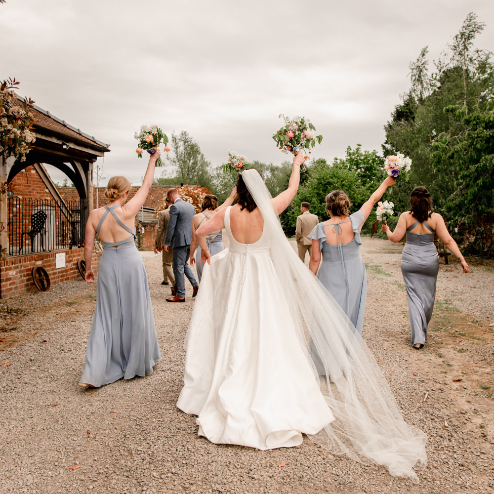 bride and bridesmaids from the back natural wedding photo at milton end farm