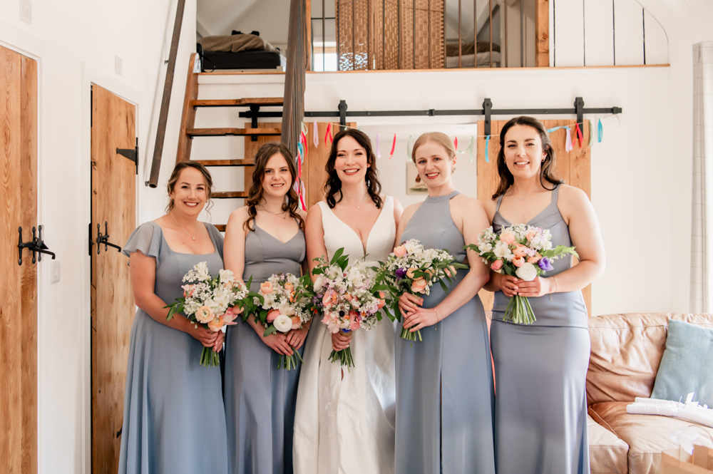bride and bridesmaids in hen house  at milton end barn