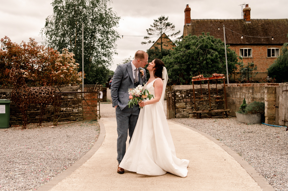 bride and groom kissing soft light photo