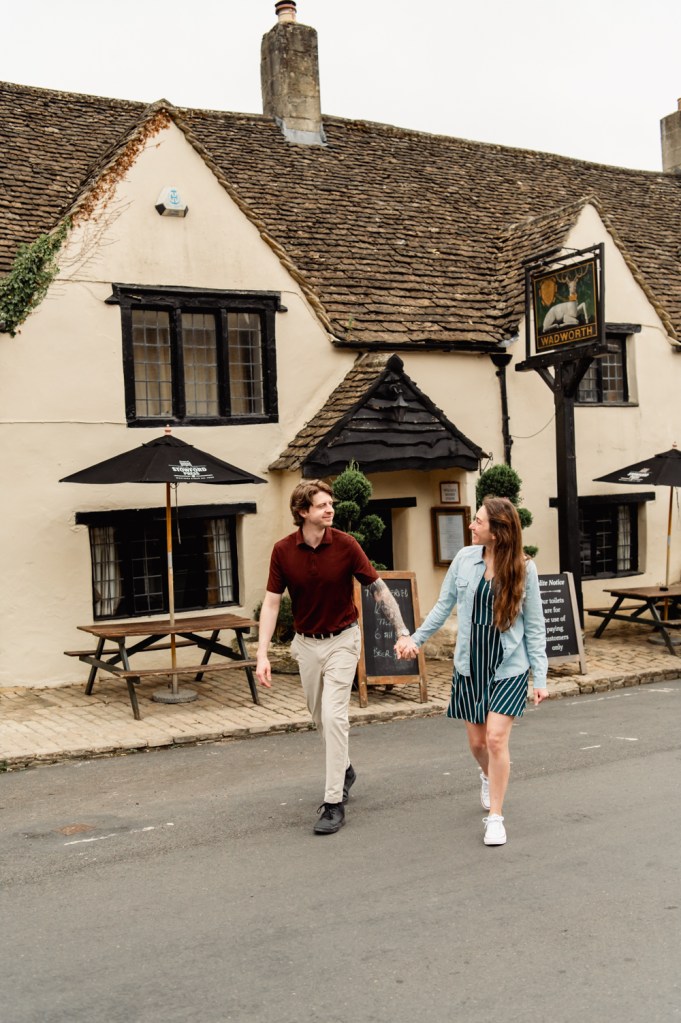 couple in front of a traditional english country pub