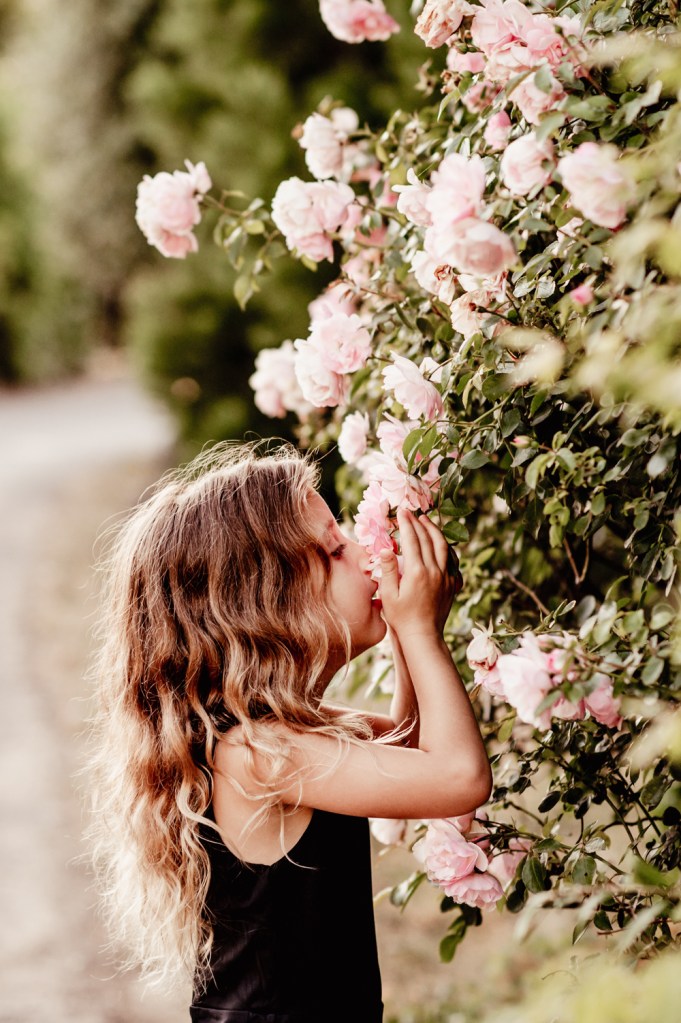 girl smelling roses