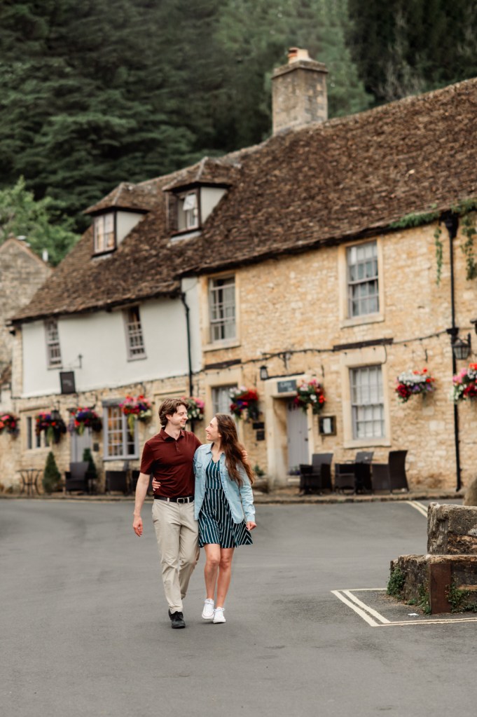 couple walking in picturesque cotswold village