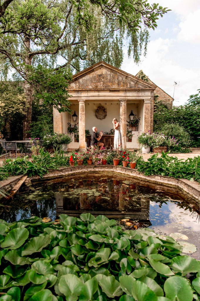 man down on one knee proposing in a picturesque garden