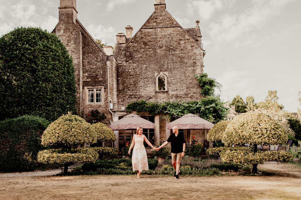 couple walking  in an atmospheric cotswold village