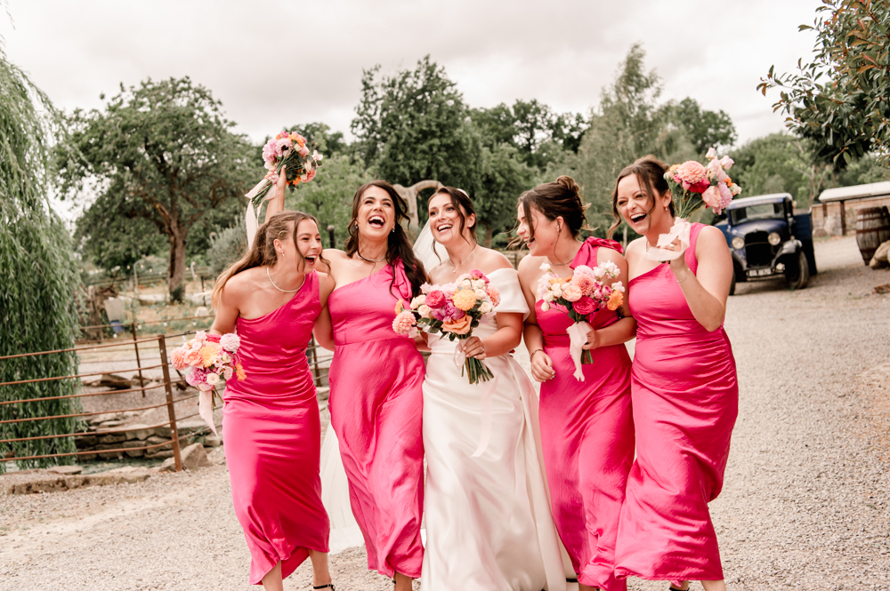 bride laughing with bridesmaids