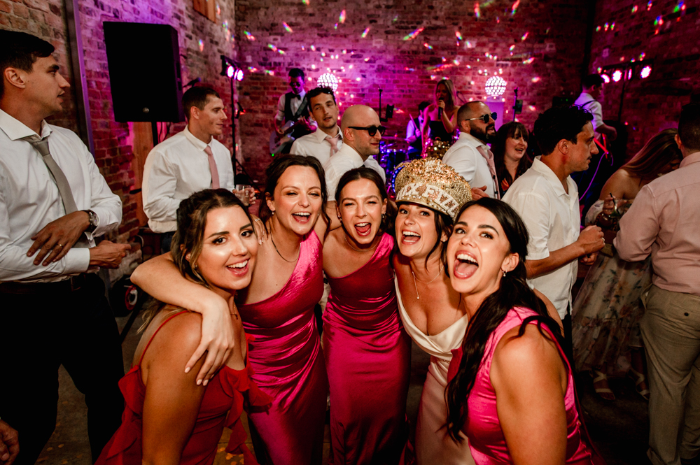 bride and bridesmaids dancing colourful wedding photos