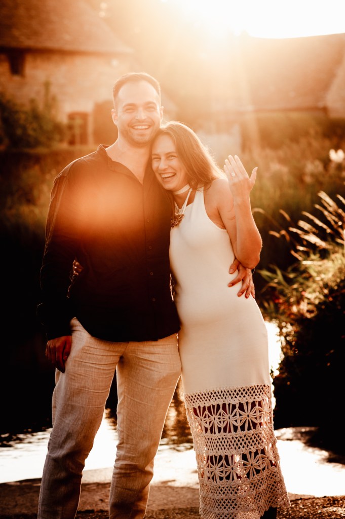 couple showing off engagement ring surprise proposal