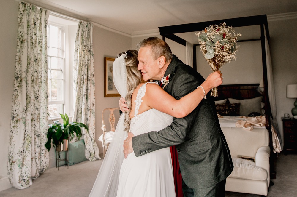 bride and father hug first look