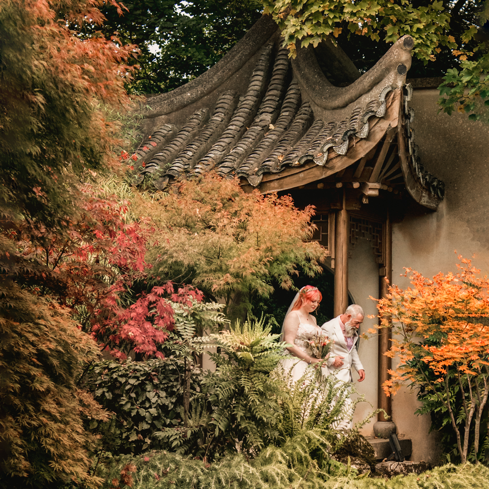 bride and dad walking down the aisle colourful woodland wedding at Matara centre
