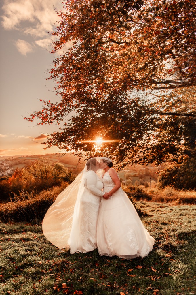 couple kissing at sunset stunning countryside cotswold wedding