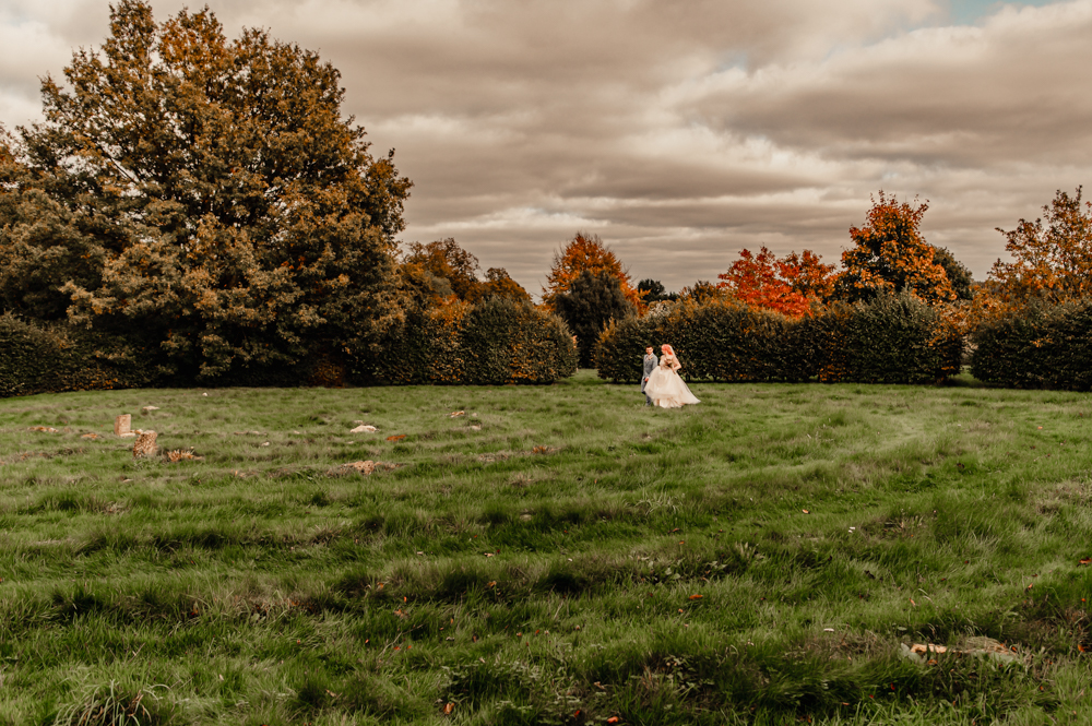 bride and groom walking in a stone circle