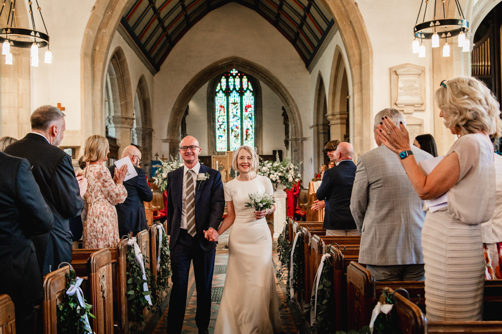 bride and groom exiting church wedding