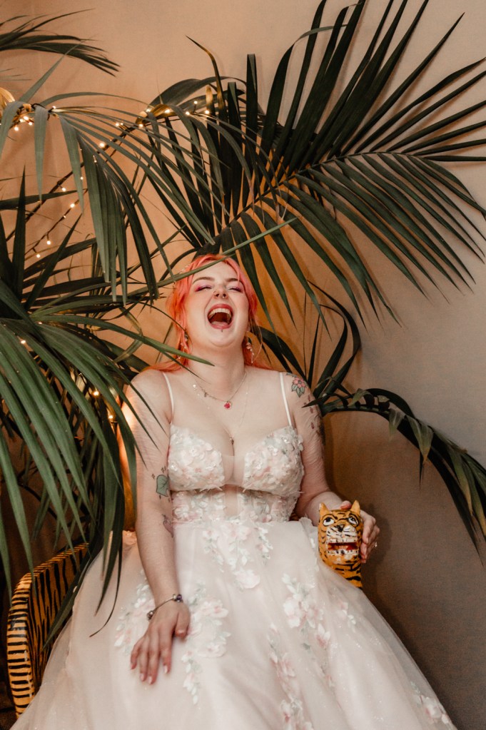 laughing bride with pink hair