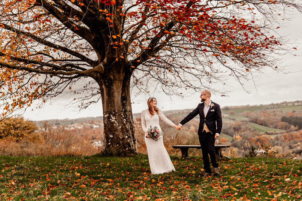 bride and groom walking under a tree cotswold wedding photography