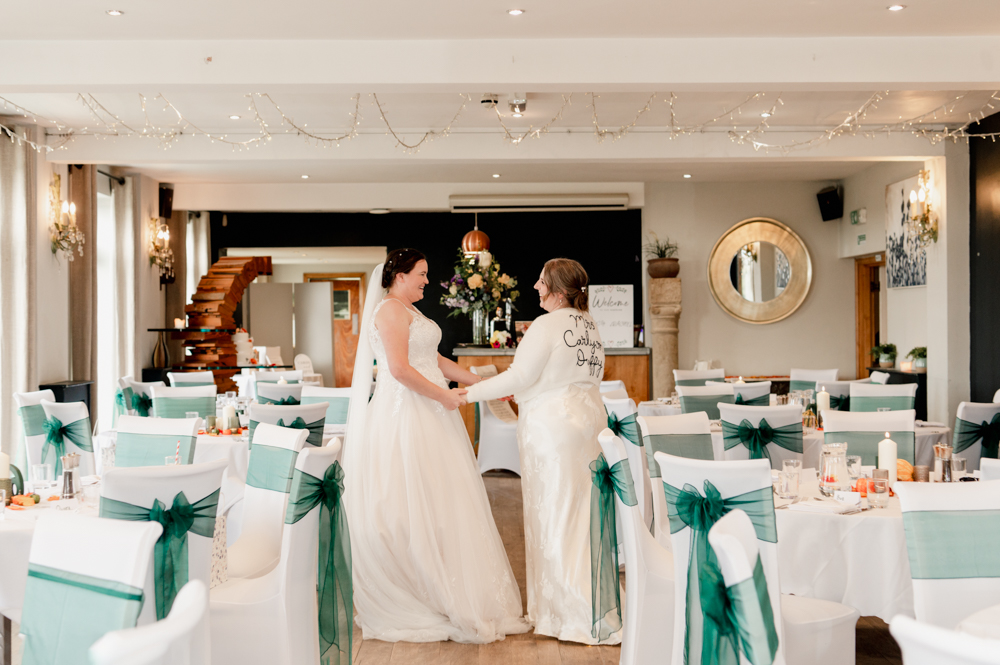 two brides at old lodge wedding breakfast room cotswolds