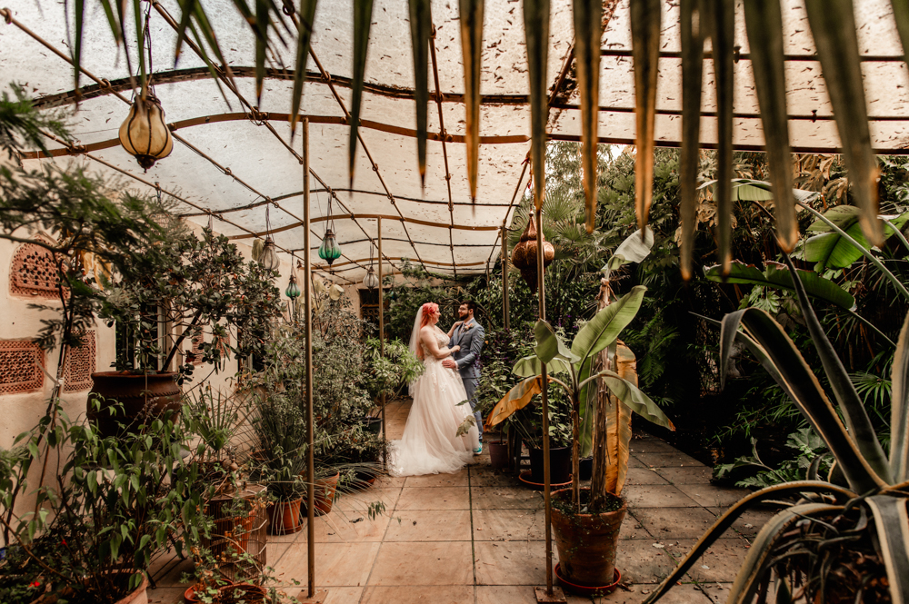 bride and groom in a lush conservatory palm house matara