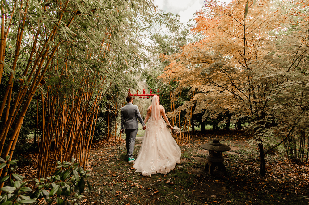 bride and groom walking in a wood