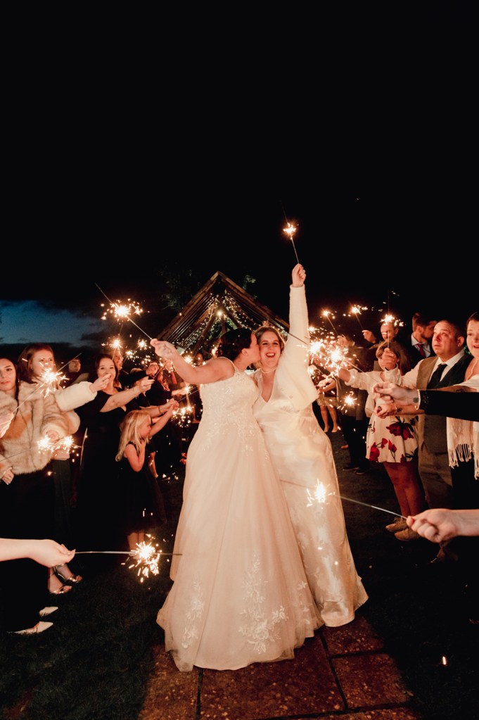 two brides kissing with sparklers cotswold wedding