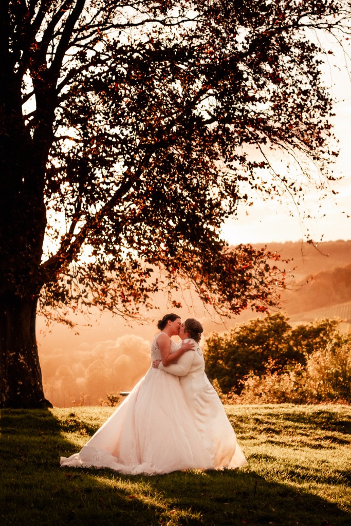 couple kissing at sunset stroud wedding