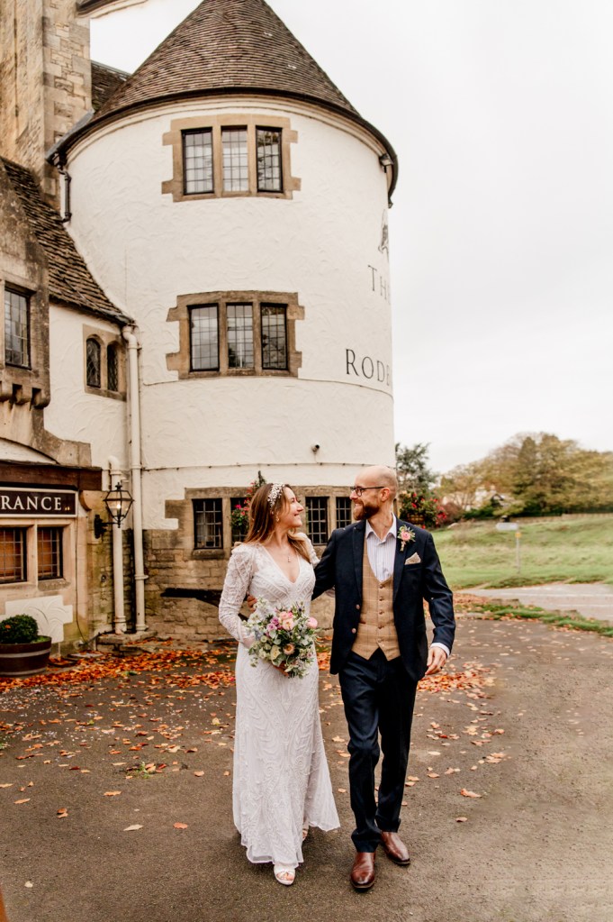bride and groom in front of the bear of rodborough hotel 