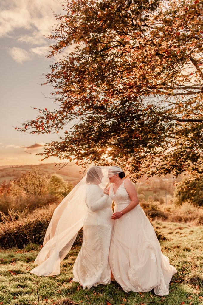 two brides under veil wedding photography