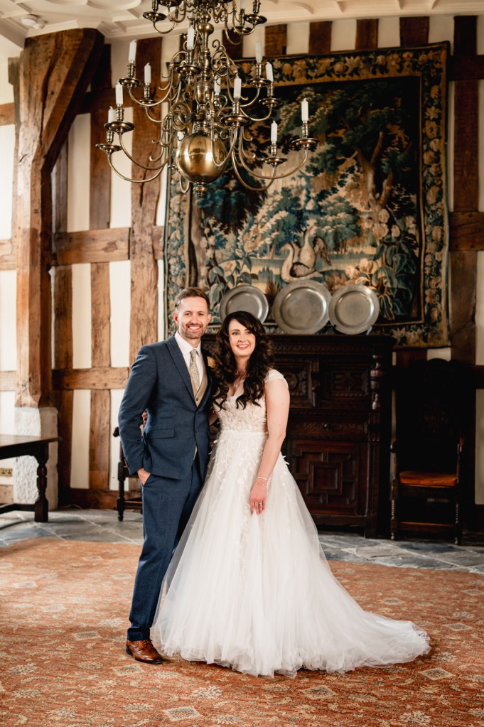 wedding couple hugging in grand hall castle wedding birtsmorton court