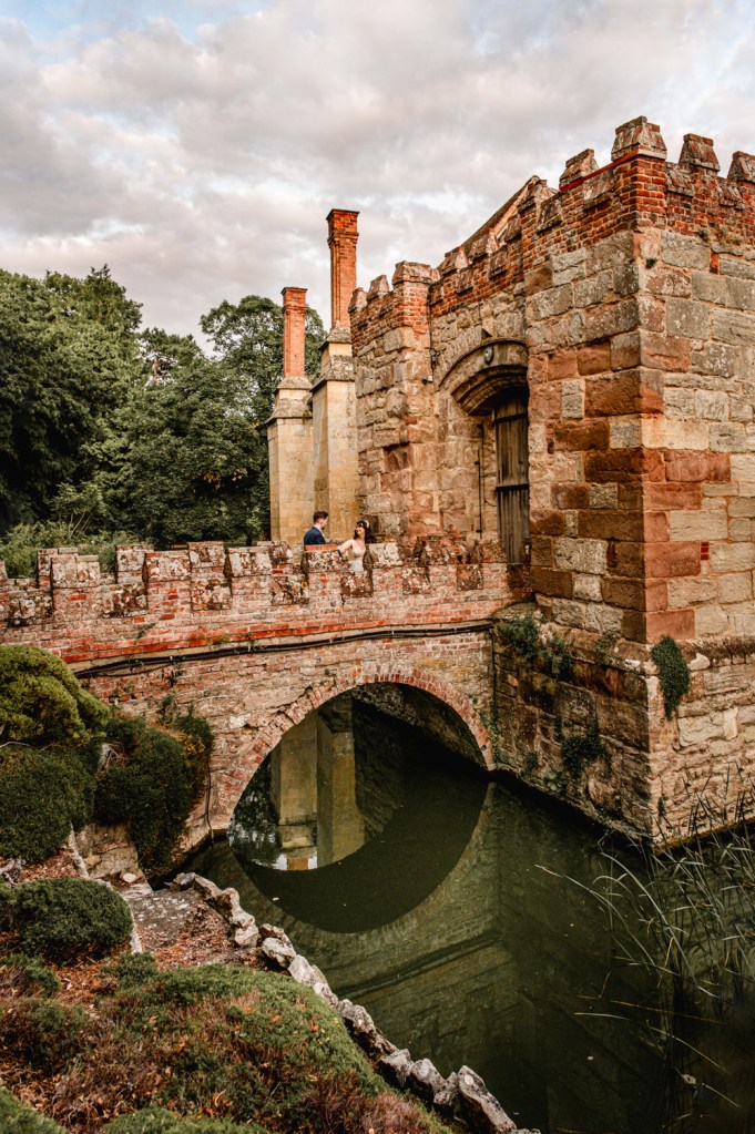 wedding couple on a romantic castle bridge Birtsmorton court