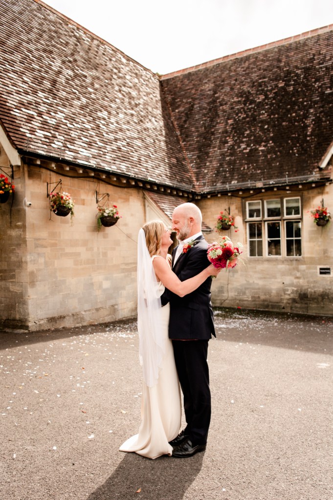 bride and groom in front of stroud registry office cotswolds