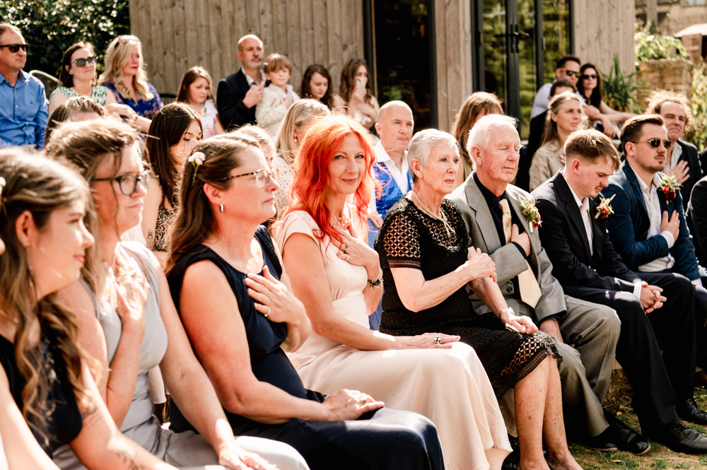 guests with hand to heart himanist wedding