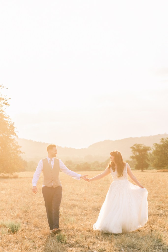bride and groom in a hazy sunlight coutryside wedding