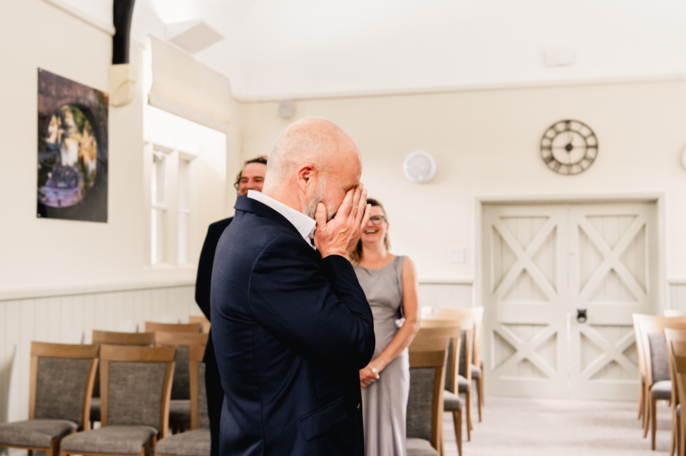 emotional groom waiting for bride