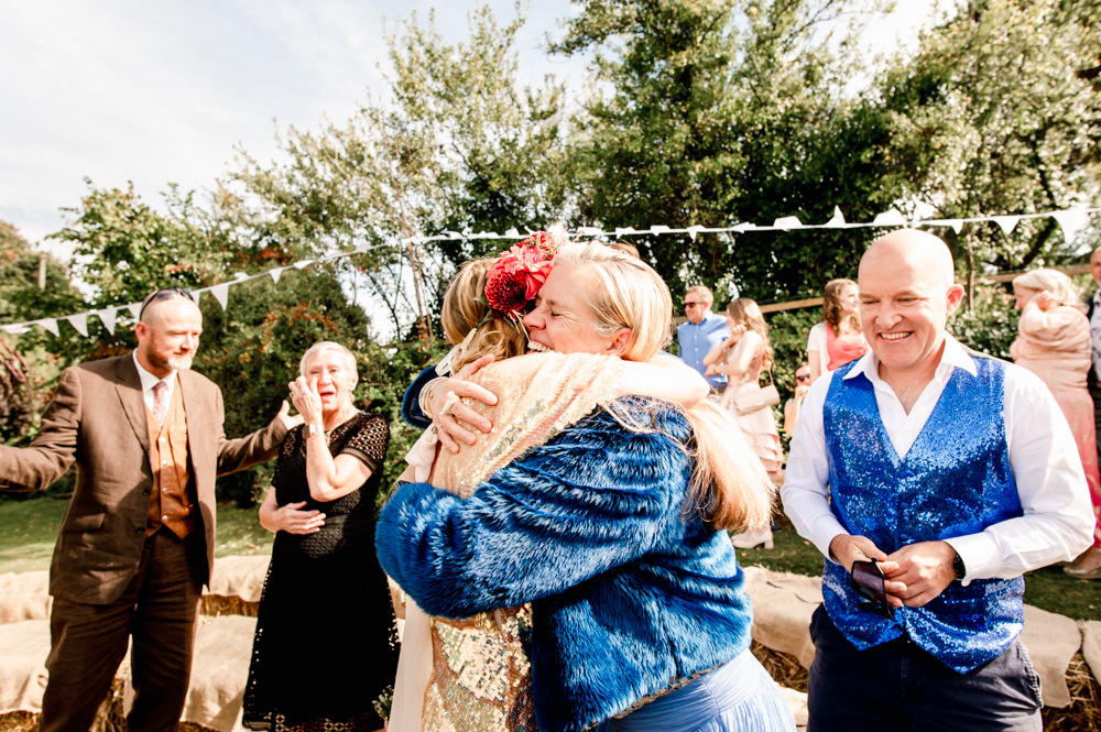 bride hugging guests natural wedding photography