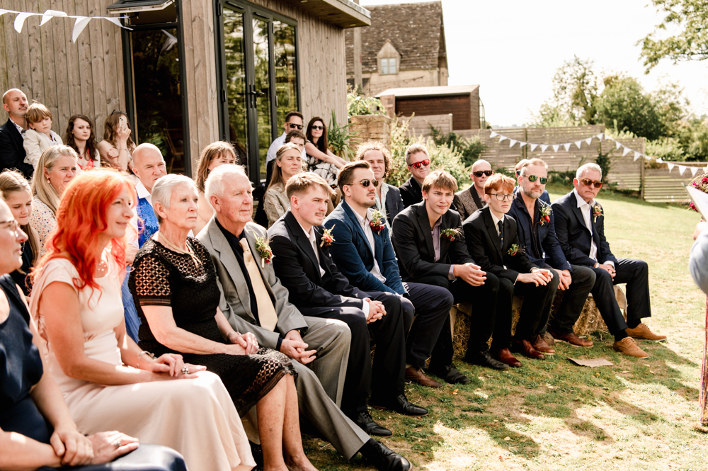 wedding guests on hay bales 