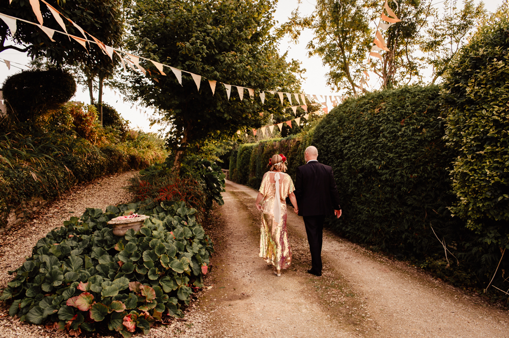 bride and groom walking on path woodland wedding 