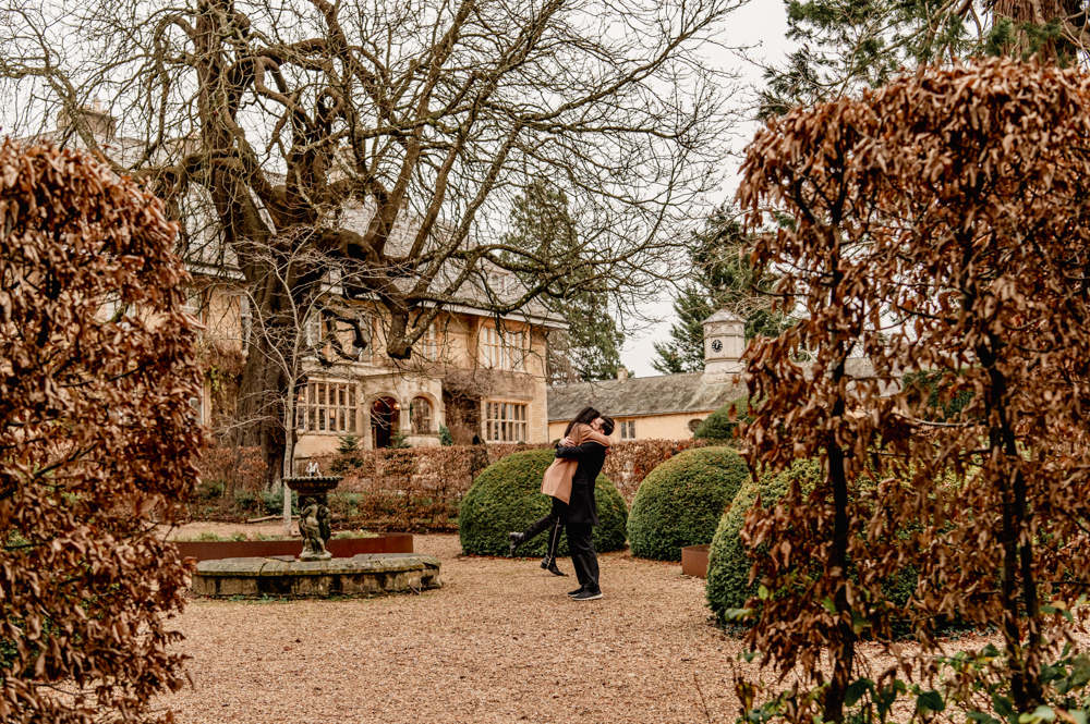 couple hugging in the cotswolds