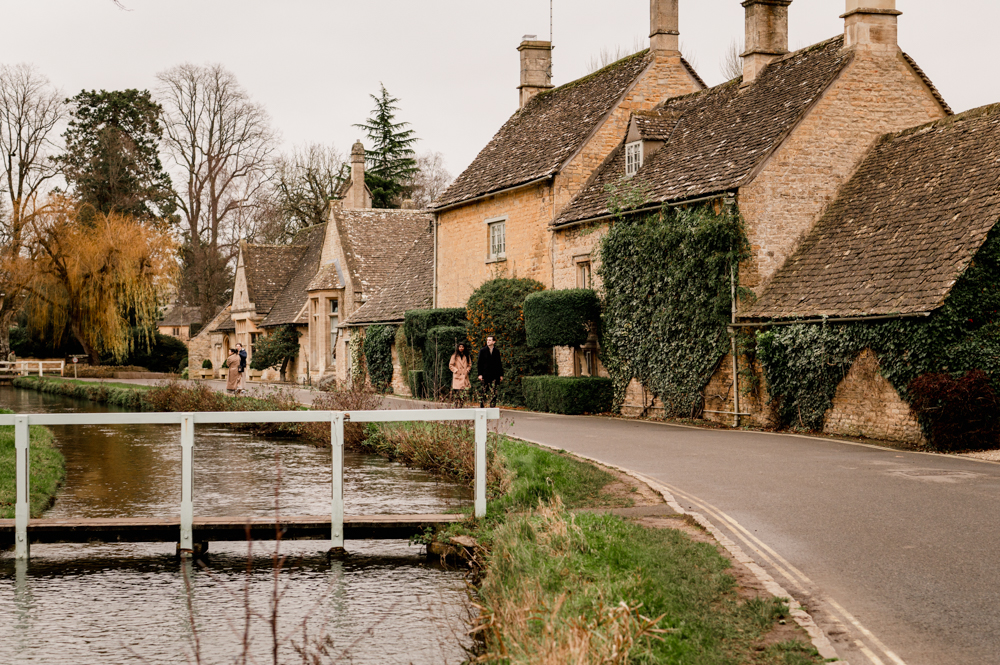 couple walking in a picturesque cotswold village in England