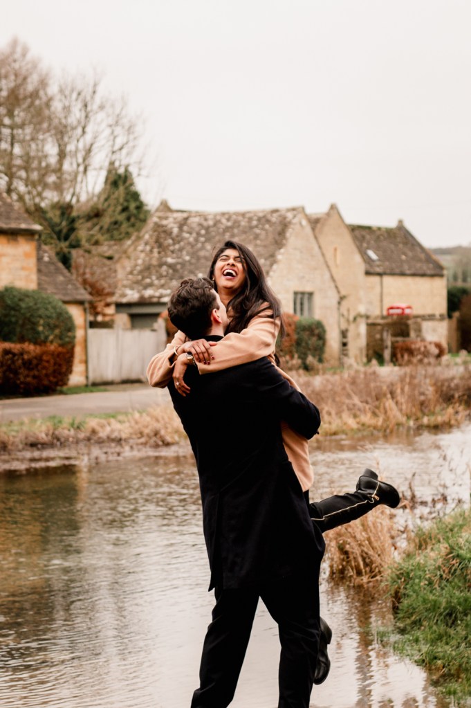 happy engaged couple in a cotswold village