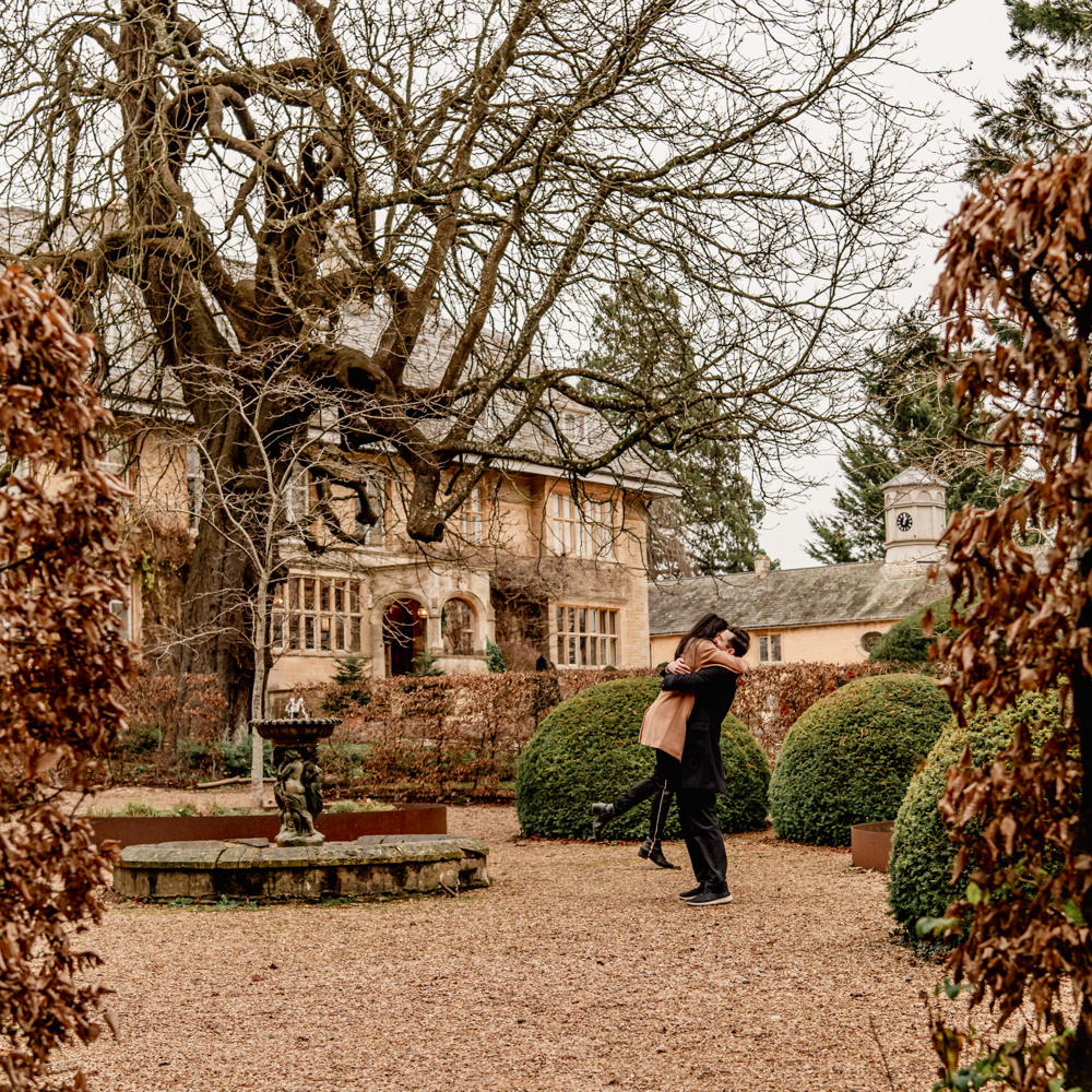 couple hugging in the cotswolds england