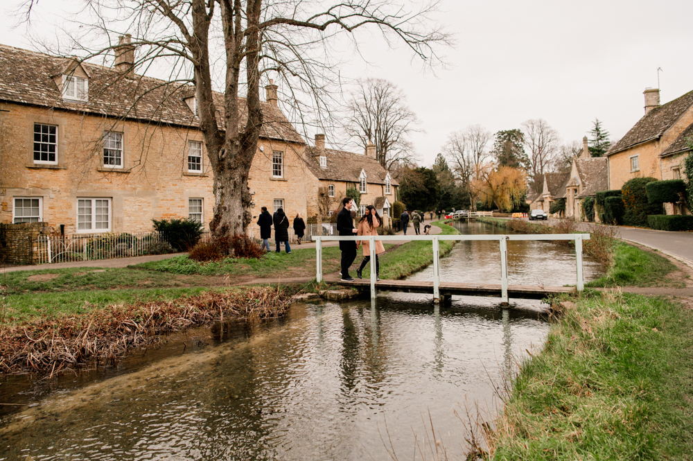 couple walking  in a cotswold village