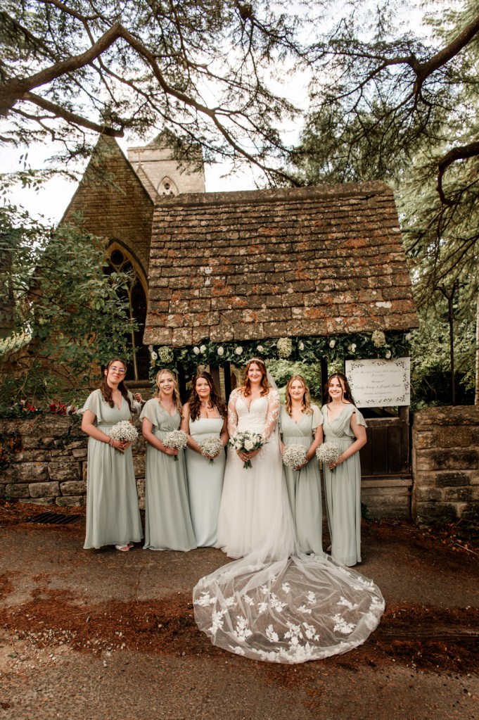 bride and bridesmaids in front of a dreamy rural  church