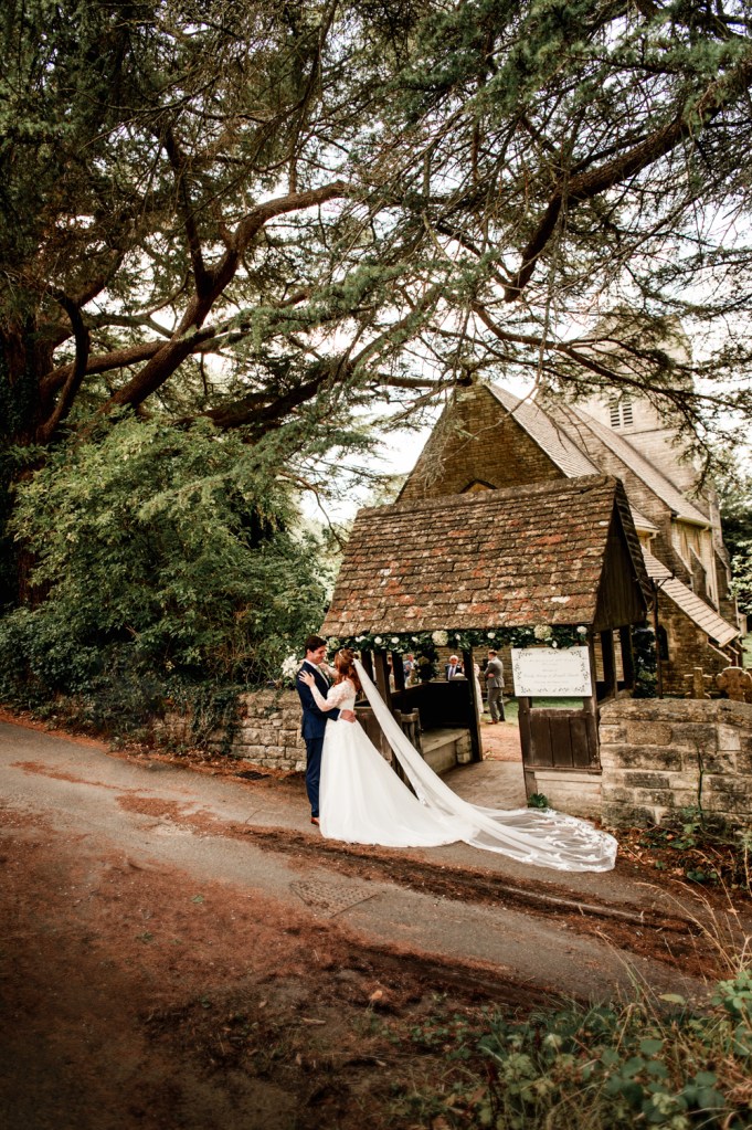 bride and groom by a dreamy church